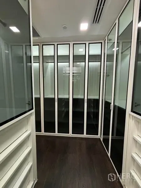Condominium for rent - Walk-in closet with glass-front wardrobes and shelving.