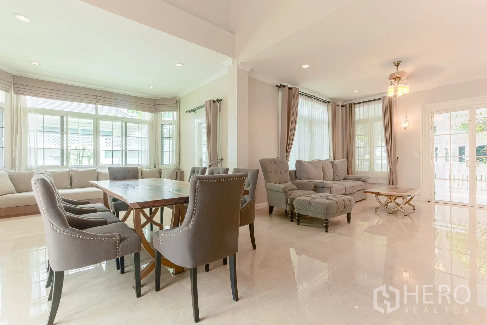Detached House for rent in Bang Na, Bangkok - Spacious living and dining area with bay window sofa and plush seating.