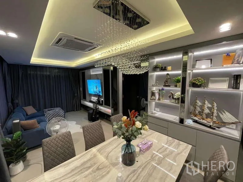 Detached House for rent - Open-plan dining and living room with crystal chandelier and display shelving.