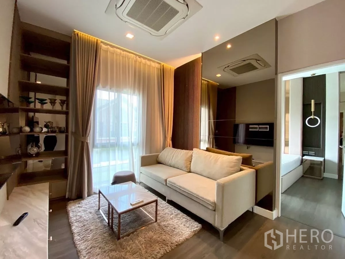 Detached House for rent in Bang Phli, Samut Prakan - Upstairs family room with sofa, built-in shelving and a doorway to the bedroom.