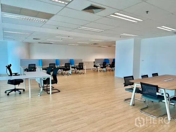 Office Space for rent - Wide open office area with clustered desks, recessed lighting, and light wood floors.