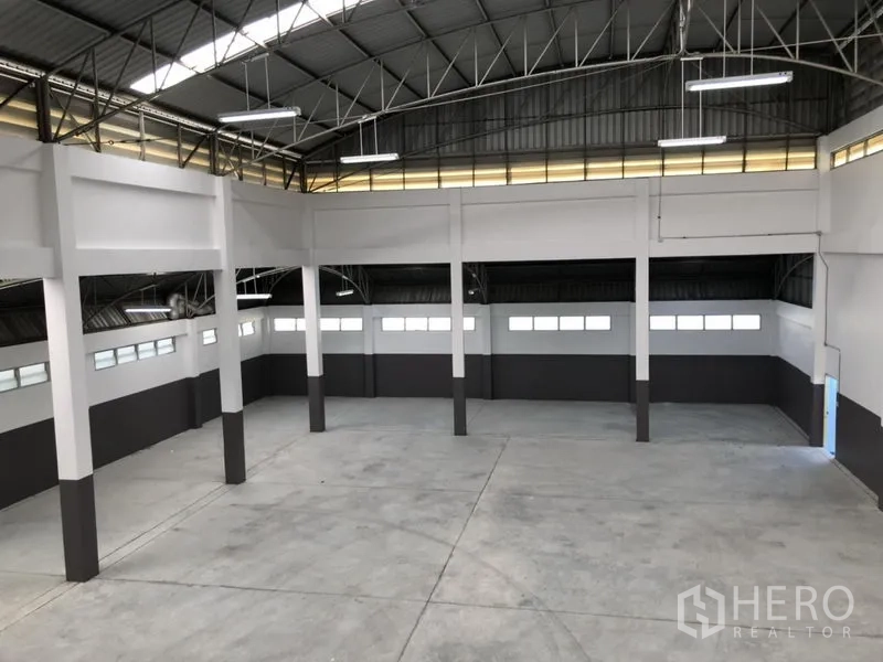 Factory for rent in Pathum Thani - Elevated view of the warehouse hall with skylights and structural columns.