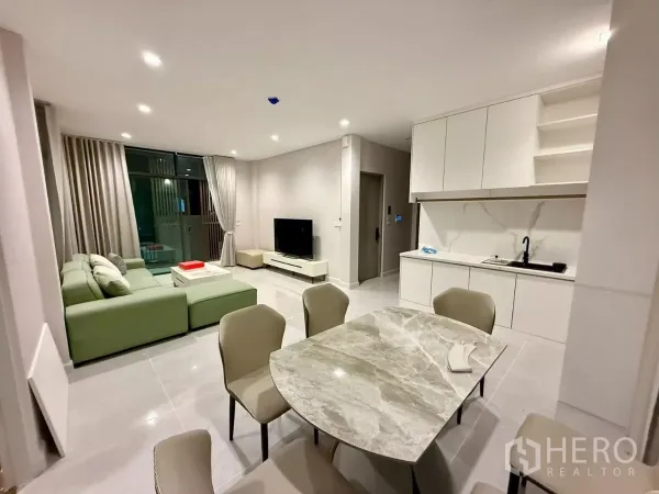 Detached House for rent in Bang Phli, Samut Prakan - Open living and dining space with marble coffee table and white pantry cabinetry.