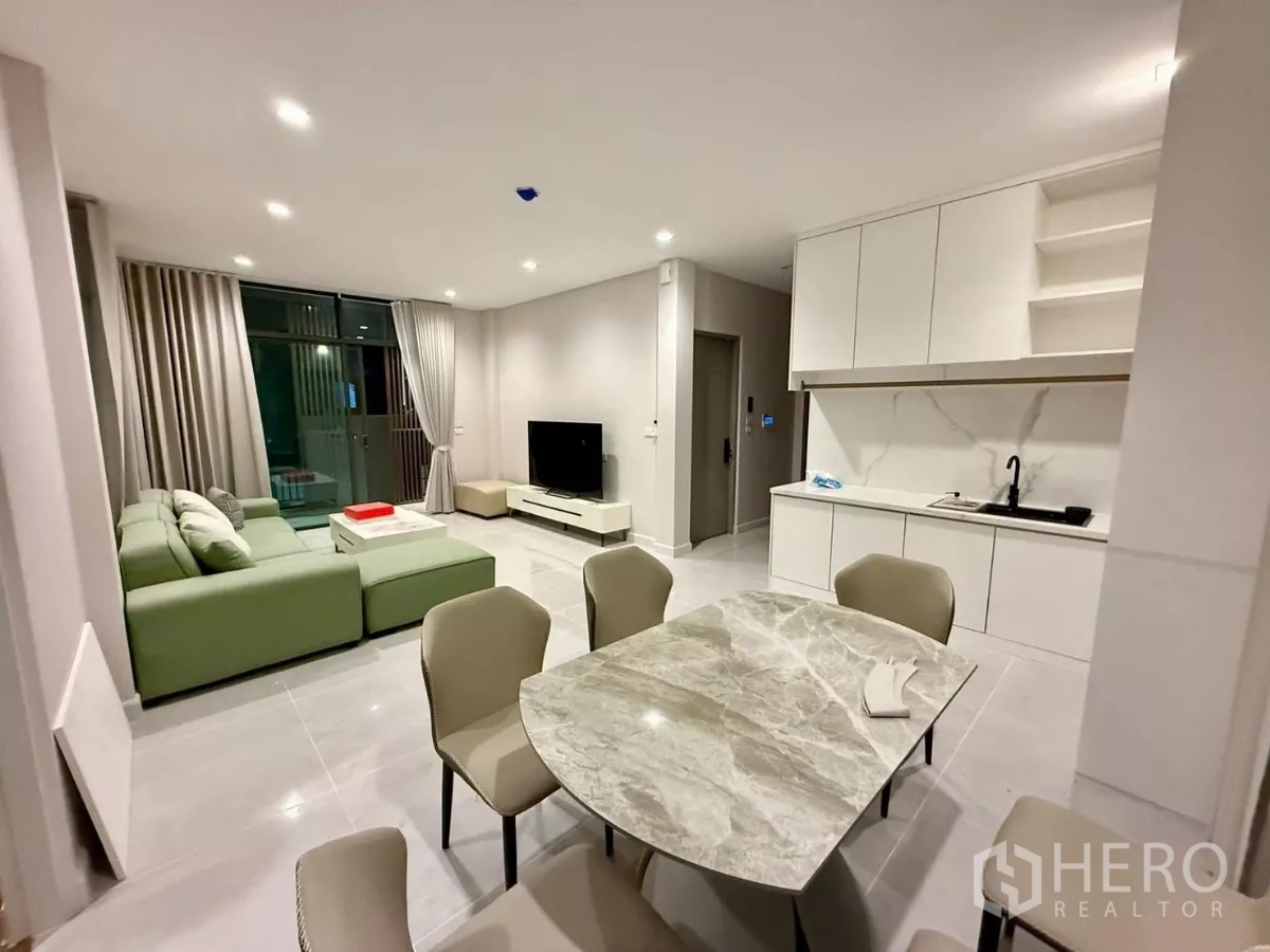 Detached House for rent in Bang Phli, Samut Prakan - Open living and dining space with marble coffee table and white pantry cabinetry.