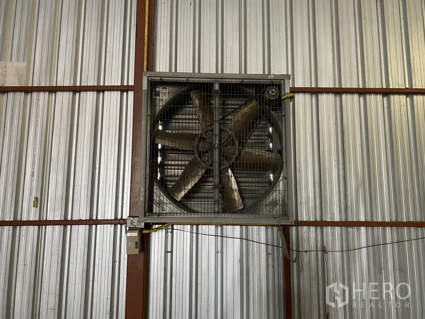 Warehouse for rent in Bueng Kum, Bangkok - Close-up of an industrial wall-mounted ventilation fan inside the warehouse.
