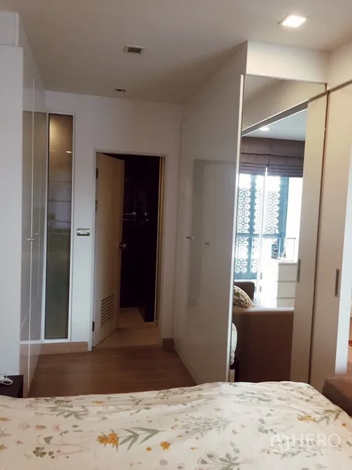 Condominium for rent or sale in Watthana, Bangkok - Bedroom corridor with wardrobes leading to the living area.