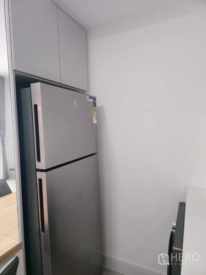 Townhouse for rent in Bang Phli, Samut Prakan - Stainless steel double-door refrigerator with overhead cabinetry in pantry corner.