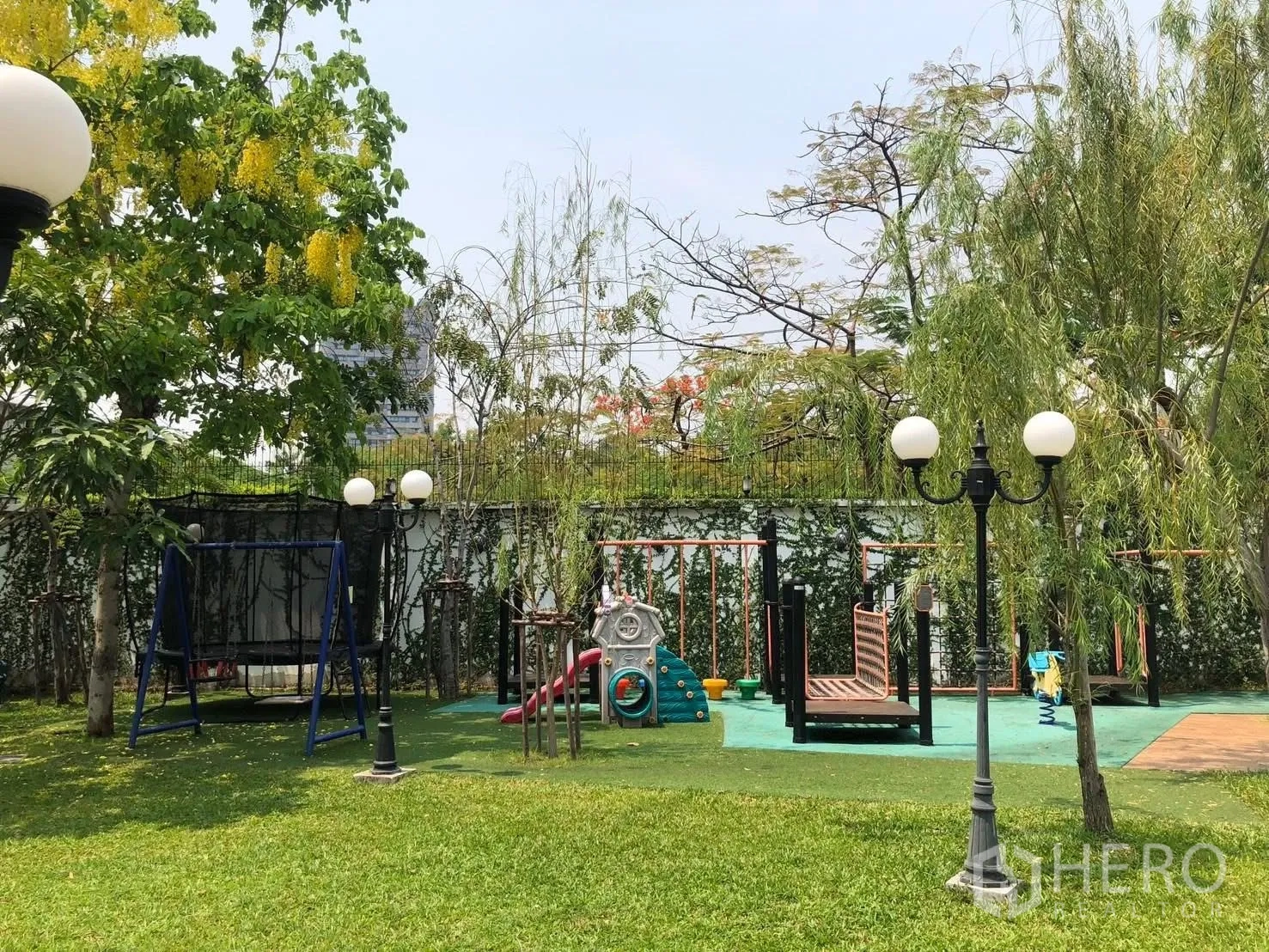Detached House for rent in Bang Na, Bangkok - Children’s playground with swings and climbing equipment on grass.