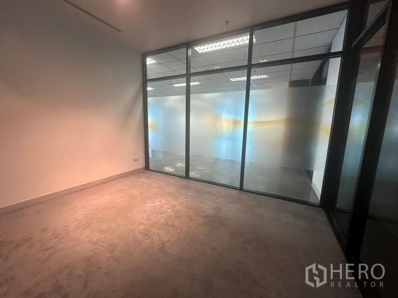 Office Space for rent in Khlong Toei, Bangkok - Small office or meeting room behind frosted glass looking into the main workspace.
