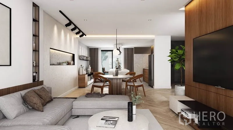 Detached House for rent in Watthana, Bangkok - View from the lounge to dining and kitchen with wood TV wall, recessed shelf, and track lighting.