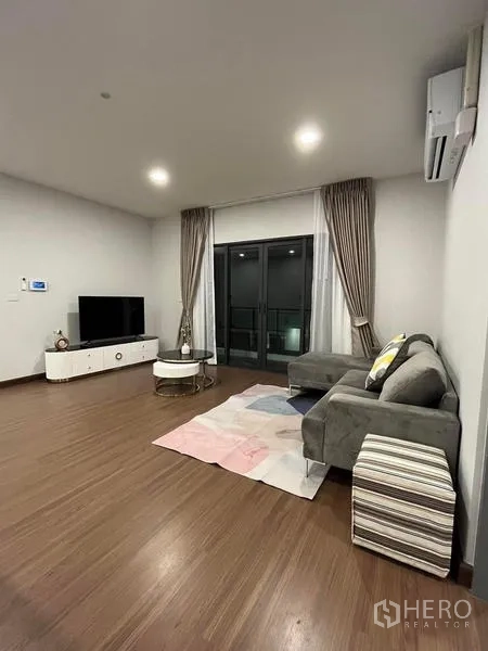 Detached House for rent - Upstairs family room with sofa, TV and sliding doors to the balcony.