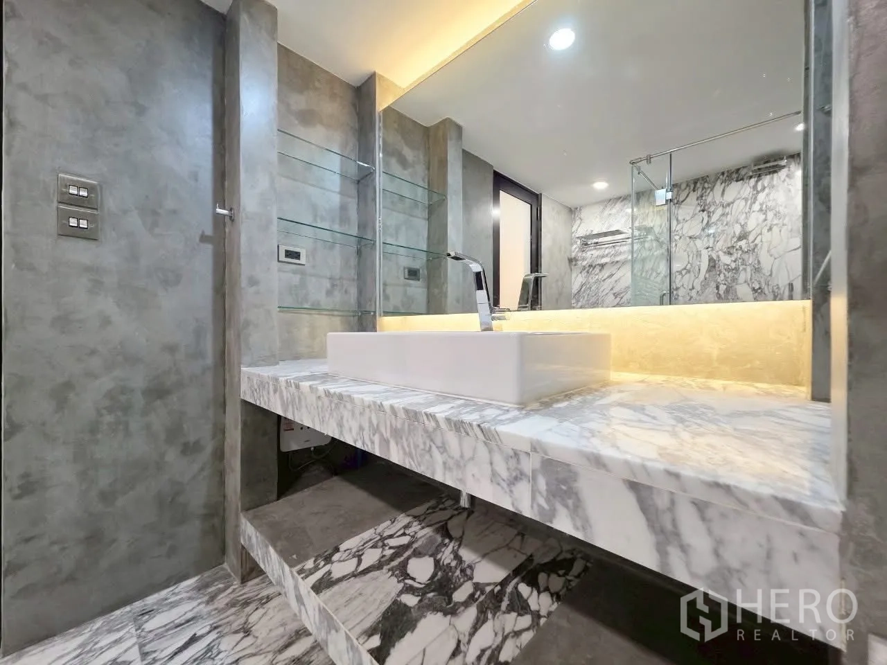 Condominium for rent in Sathon, Bangkok - Close view of marble countertop with vessel sink in a modern bathroom.