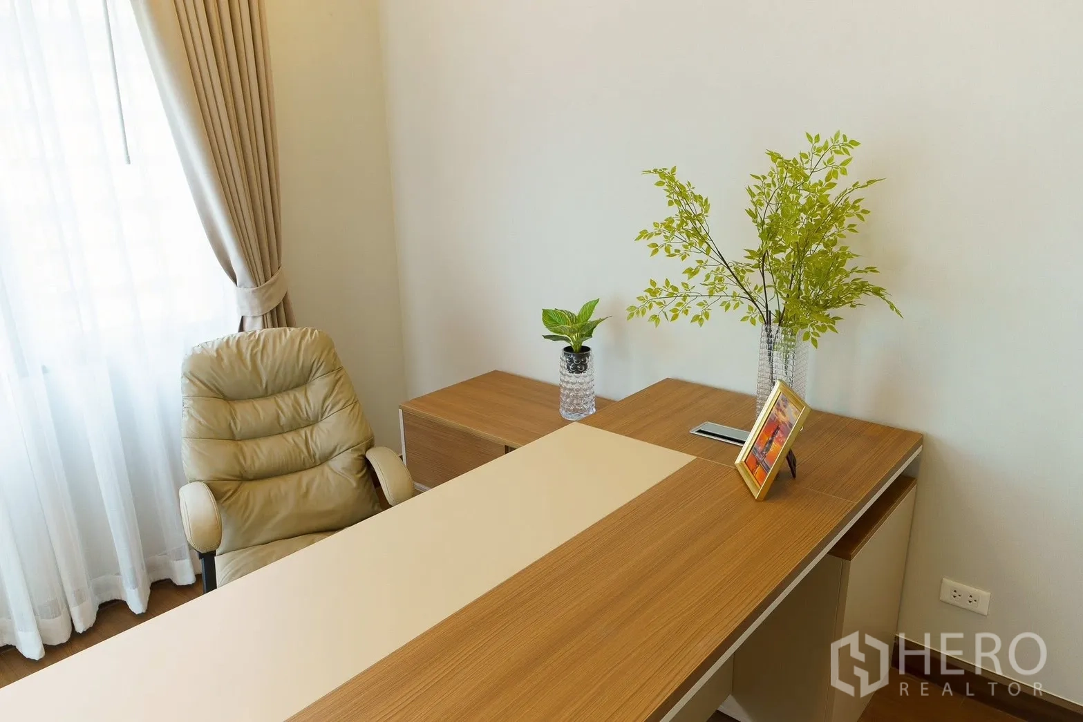 Detached House for sale in Bang Phli, Samut Prakan - Bright home office with a wooden desk beside a curtained window