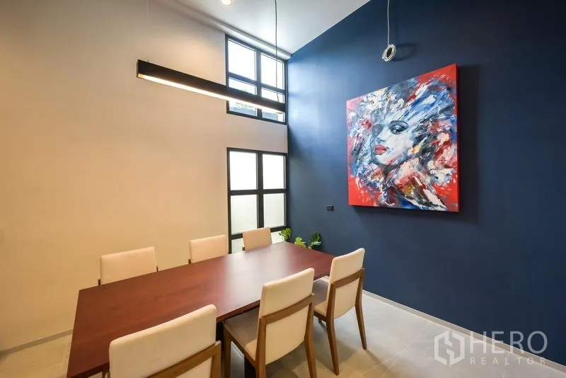 Home Office for rent or sale - Modern dining or meeting room with high ceiling, blue feature wall and abstract artwork.