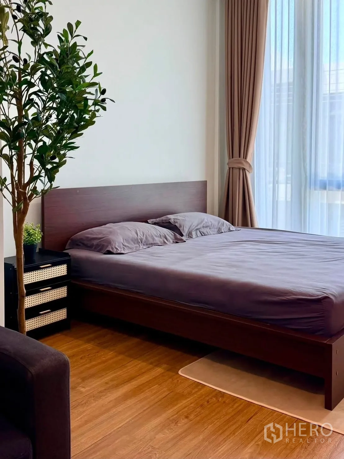 Townhouse for rent in Bang Phli, Samut Prakan - Bedroom with a queen bed beside a large window with sheer and blackout curtains.