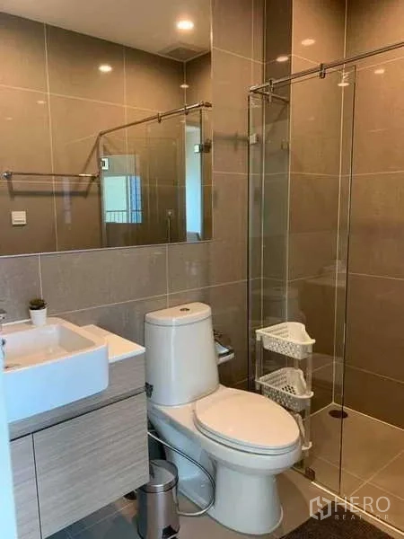 Condominium for rent - Contemporary bathroom with glass shower enclosure, vanity and toilet