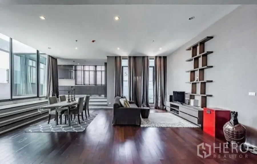 Condominium for rent - Contemporary living-dining space with hardwood floors and full-height curtains.