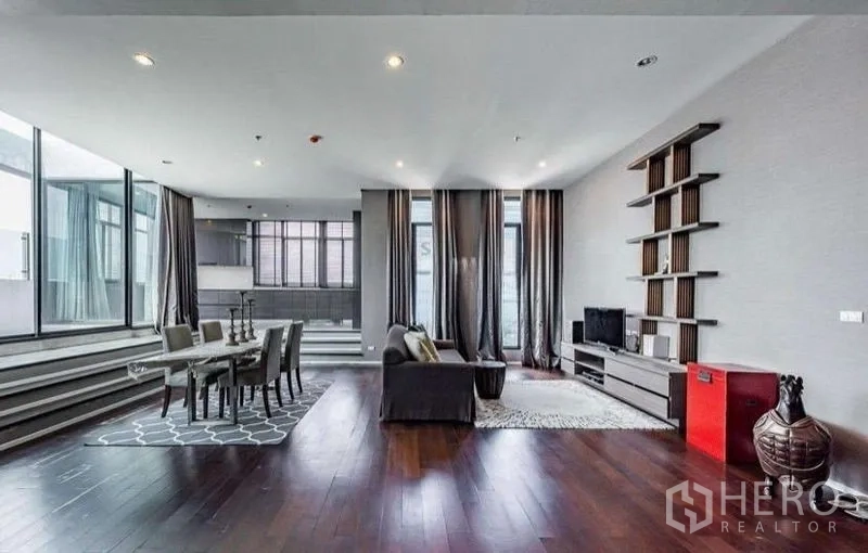 Condominium for rent - Contemporary living-dining space with hardwood floors and full-height curtains.