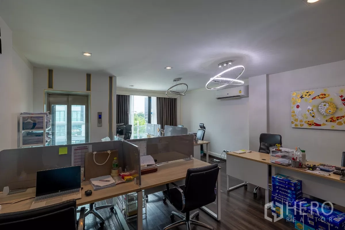 Home Office for sale in Don Mueang, Bangkok - Bright office room with workstations, modern ring chandeliers and balcony view.