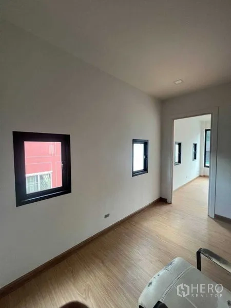 Home Office for sale - Compact office nook with multiple small windows and timber-style floors.