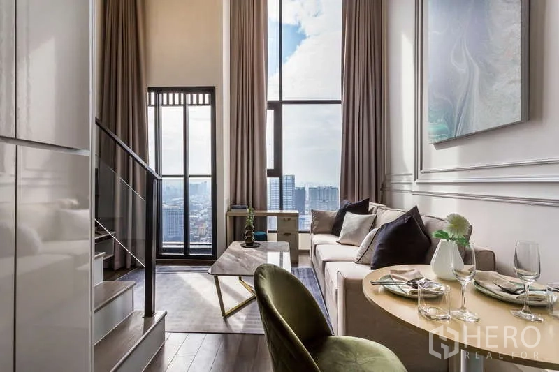 Condominium for rent or sale - Light-filled lounge with panoramic windows and city view.