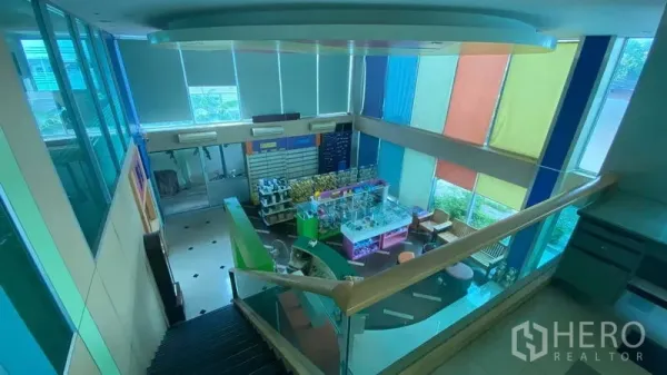 Office Space for sale in Bang Kapi, Bangkok - Double-height lobby with colorful blinds, staircase and a reception or showroom-style display area.