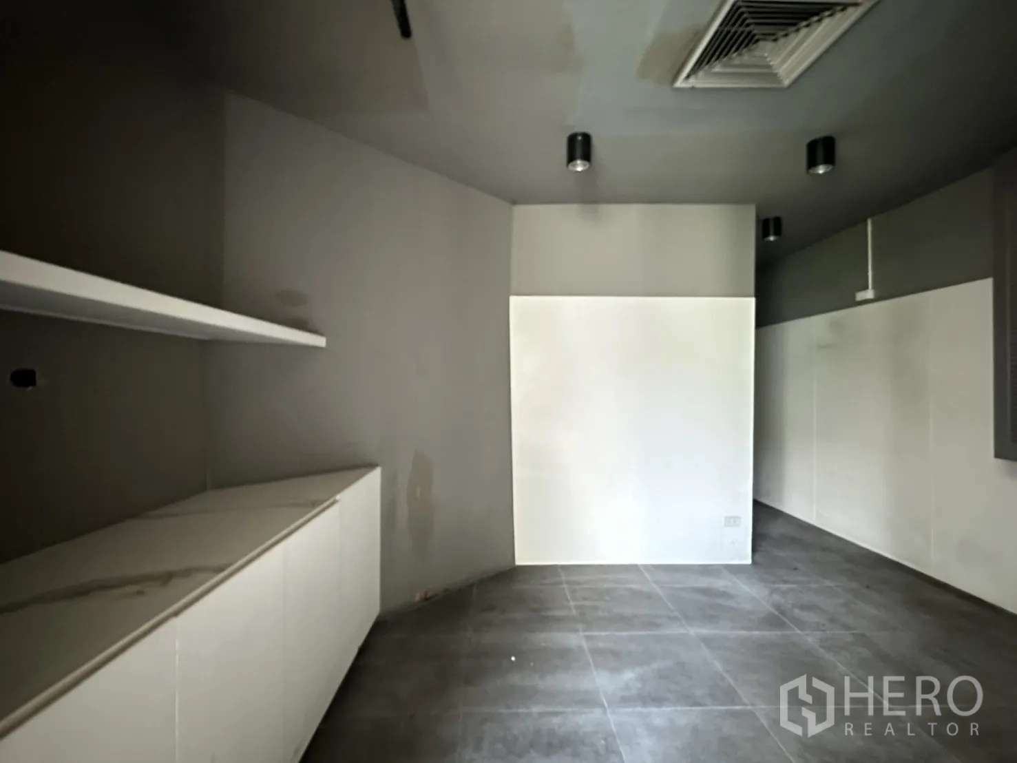 Retail Space for rent in Watthana, Bangkok - Back room with dark ceiling, white cabinetry, and tiled floor.
