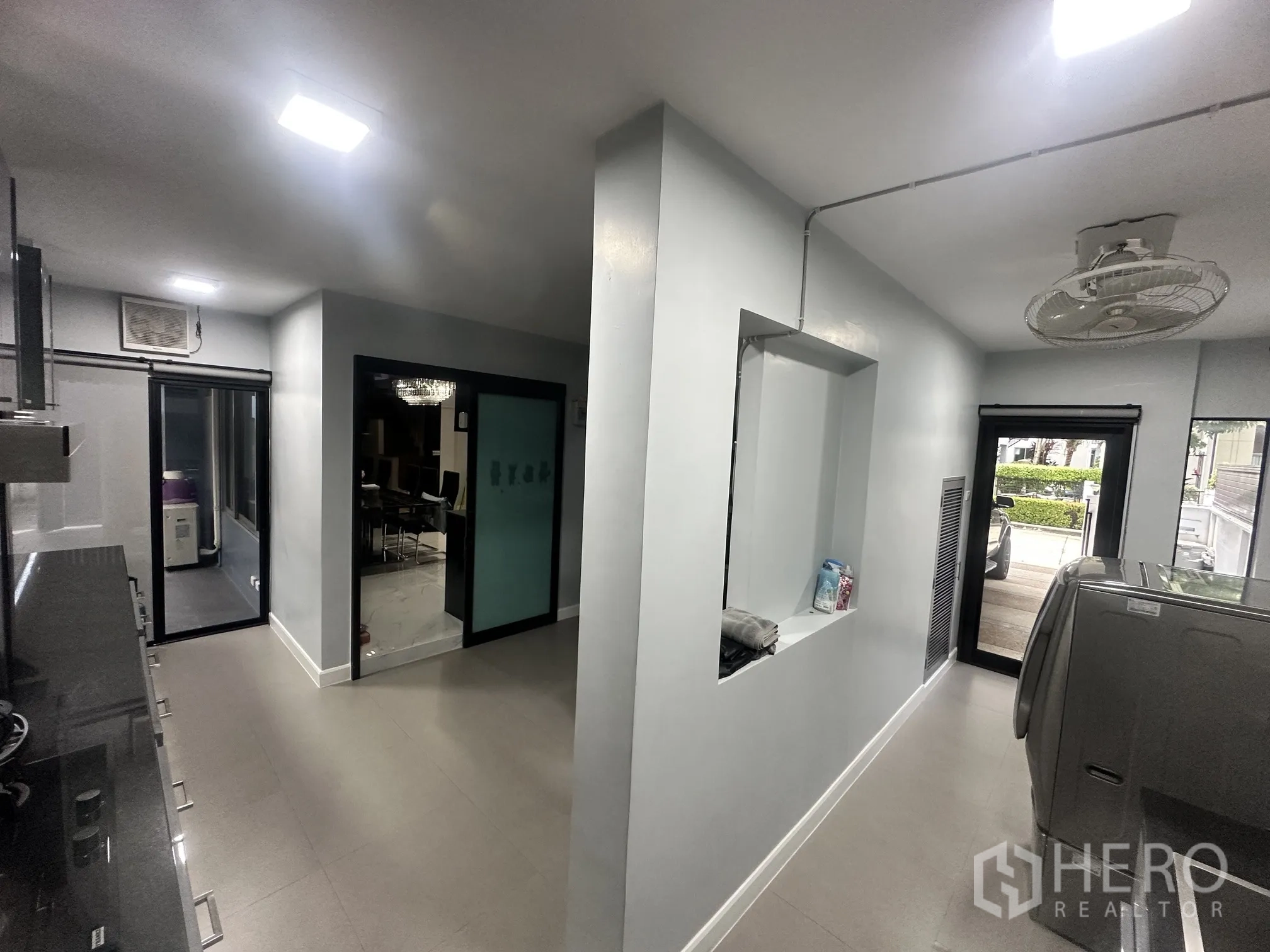 Detached House for sale in Pak Kret, Nonthaburi - Utility and laundry area with washing machine and multiple access doors.