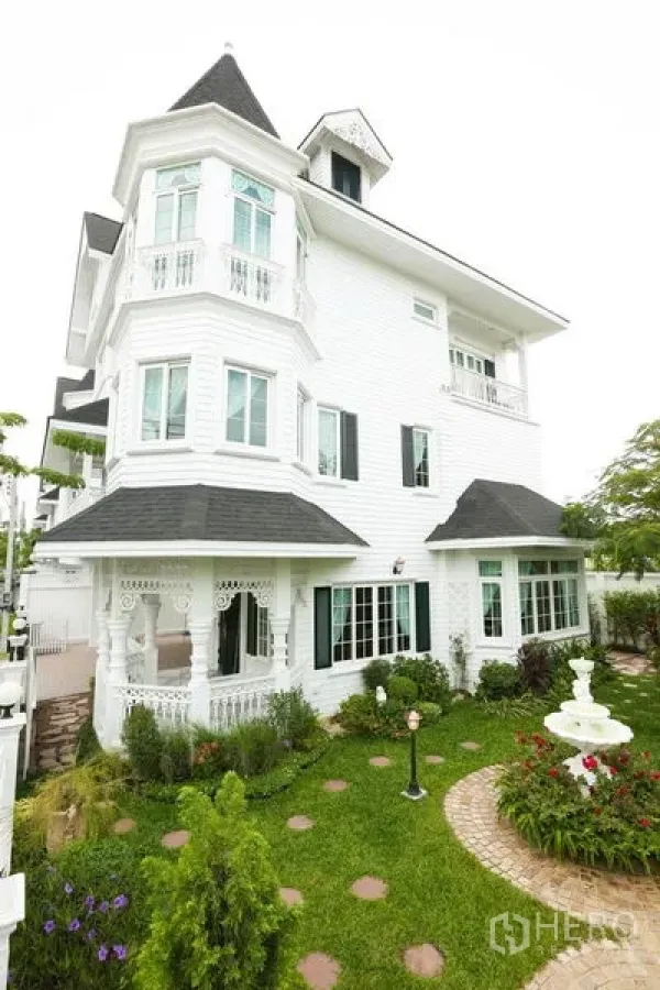 Detached House for rent in Bang Na, Bangkok - Elegant white three-storey detached house with turret, bay windows, landscaped lawn and garden fountain.