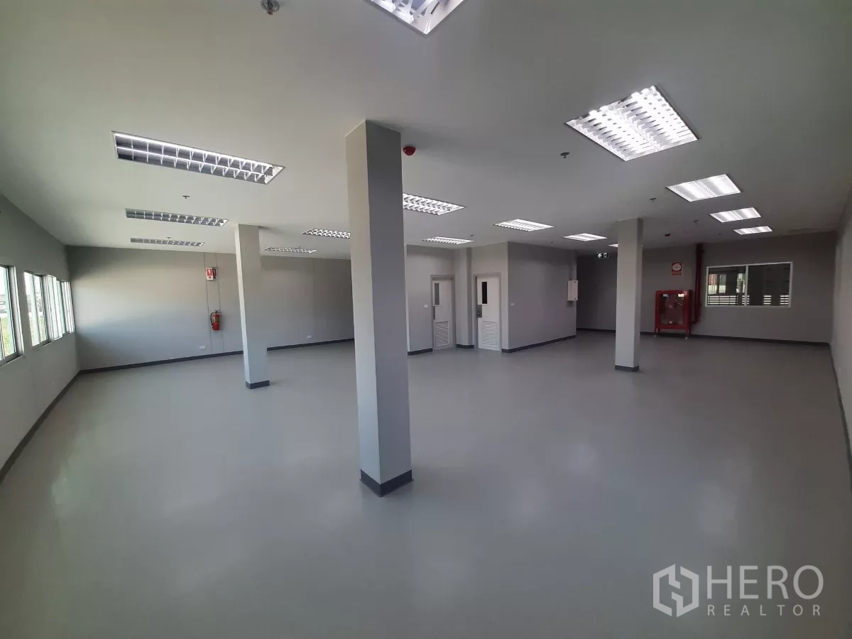 Factory for rent in Bang Lamung, Chon Buri - Office interior with fire hose cabinet and natural light.