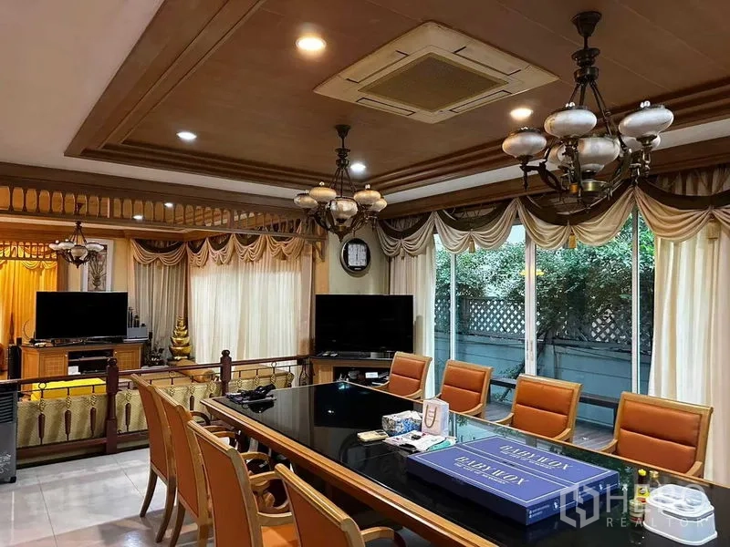 Detached House for sale in Bang Khun Thian, Bangkok - Formal dining or meeting room with a long table, chandeliers and large windows.
