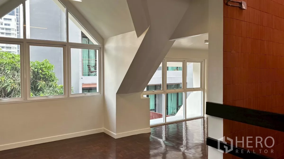 Home Office for rent in Watthana, Bangkok - Corner room with triangular windows and terracotta feature wall detail.