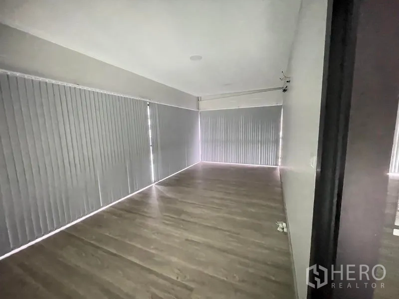 Office Space for rent in Bang Na, Bangkok - Private room with wood floors and full-height blinds, ready for office setup.