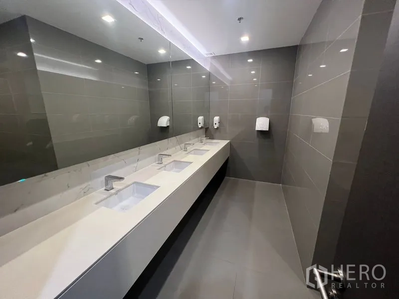 Office Space for rent - Additional washroom area with multiple sinks and a full-length mirror.