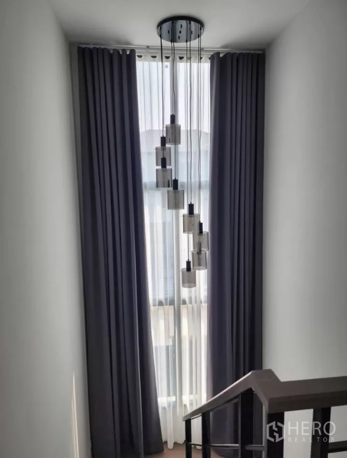 Detached House for rent in Bang Phli, Samut Prakan - Staircase landing with tall window, blackout curtains and pendant lights