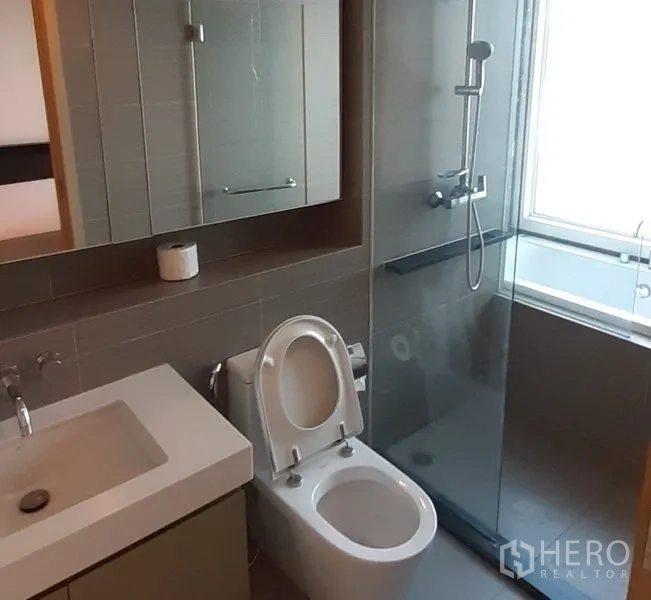 คอนโด ให้เช่าในKhlong Toei, Bangkok - ห้องน้ำกระเบื้องสีเทา พร้อมตู้ล้างหน้า และห้องอาบน้ำกระจกรับแสงธรรมชาติ