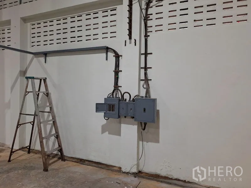 Warehouse for rent in Rat Burana, Bangkok - Electrical control panels mounted on the interior wall of the warehouse.