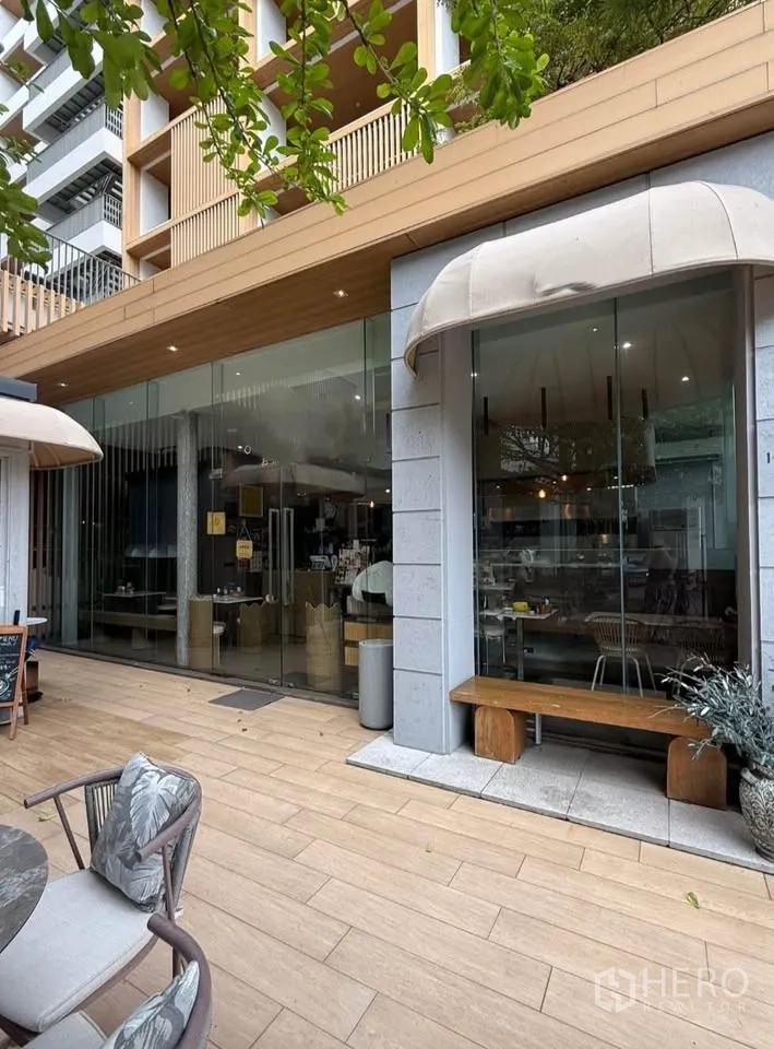 Retail Space for rent in Watthana, Bangkok - Street-level glass facade with awnings and a wooden deck outside.