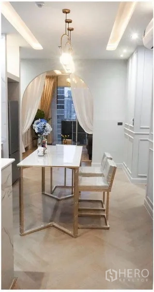 คอนโด ให้เช่าหรือขาย - พื้นที่ทานอาหาร โคมไฟห้อยสีทอง และซุ้มโค้งกรอบวิวเมือง