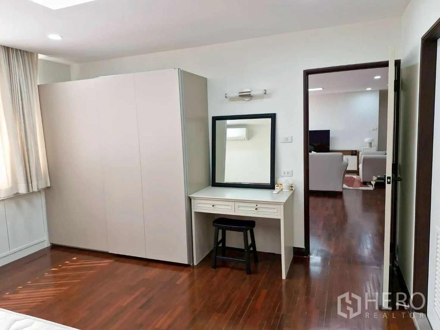 Condominium for rent in Khlong Toei, Bangkok - Bedroom corner with dressing table, mirror and wardrobe facing the living room.