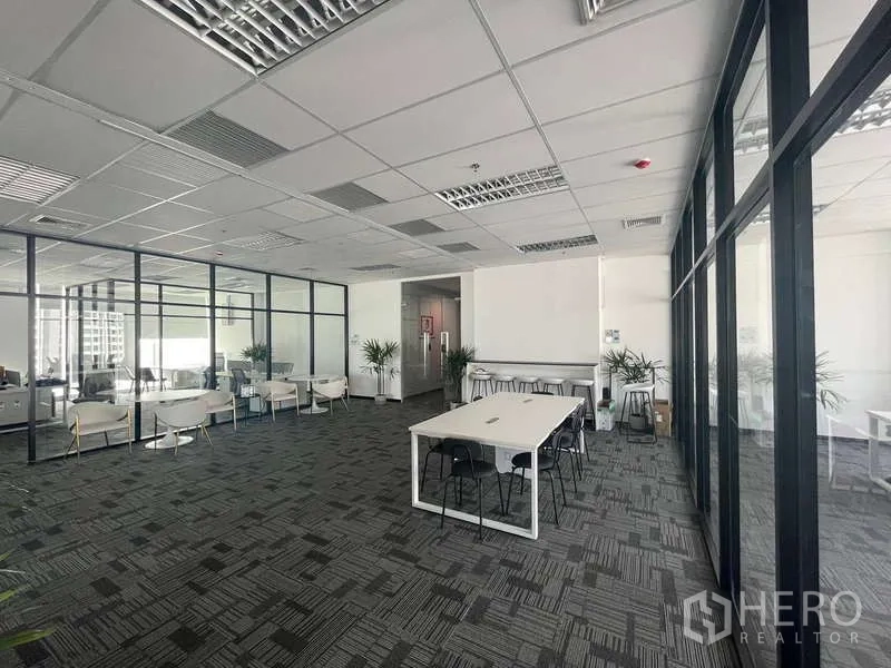 Office Space for rent in Bang Kapi, Bangkok - Spacious office floor with glass-partitioned rooms, collaboration tables and lounge seating with natural light.