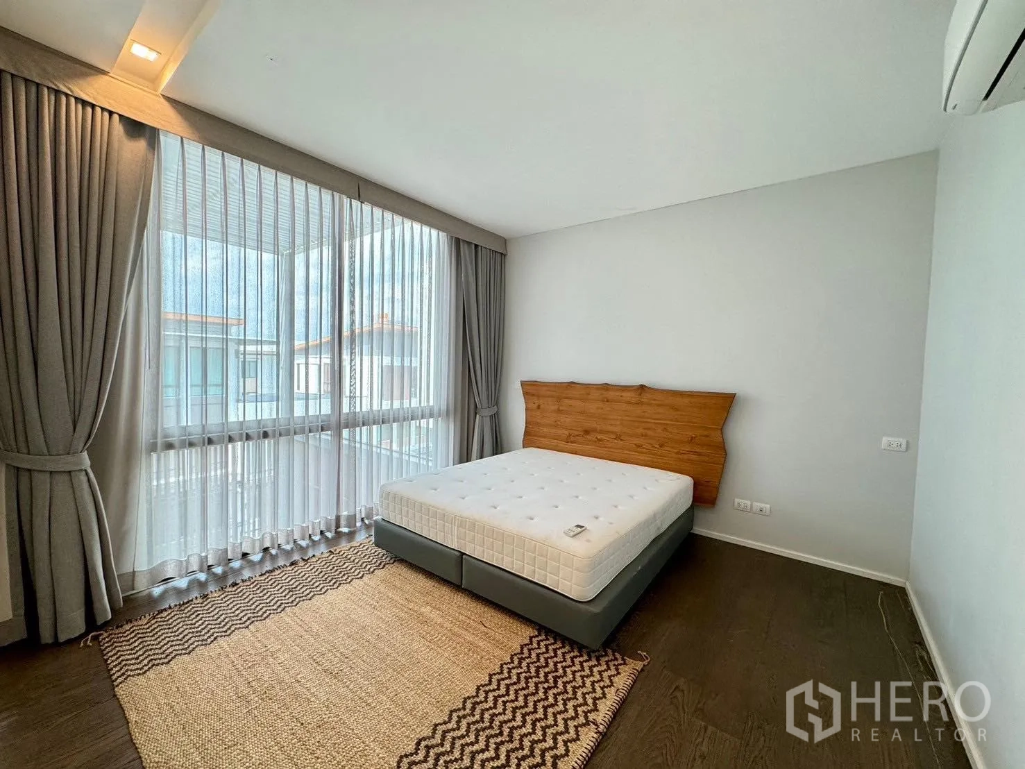 Detached House for rent or sale in Prawet, Bangkok - Bright bedroom with mattress, sheer curtains and large windows.