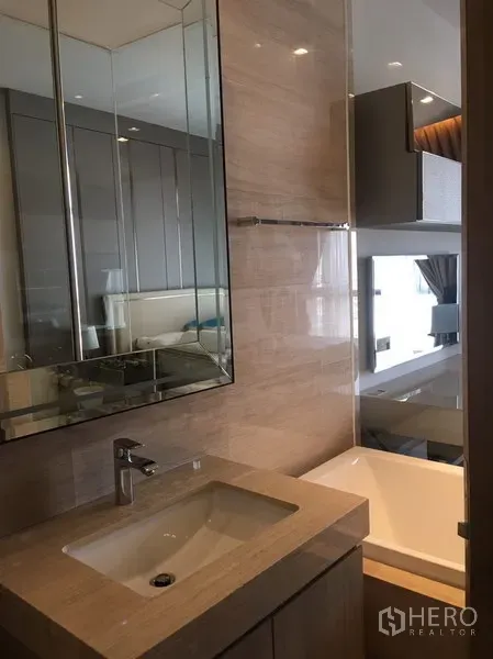 Condominium for rent in Watthana, Bangkok - Contemporary bathroom with stone vanity, mirrored cabinet and bathtub with glass partition.
