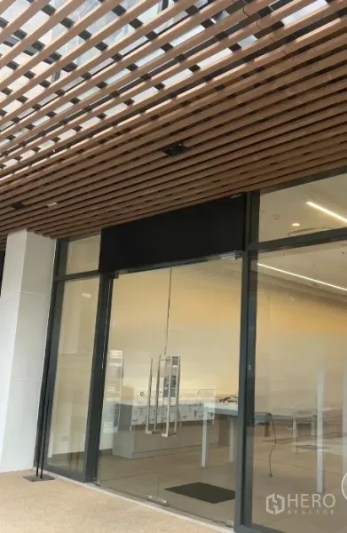 Retail Space for rent - Modern retail storefront with full-height glass doors and a wooden slat canopy in Ekkamai, Bangkok.