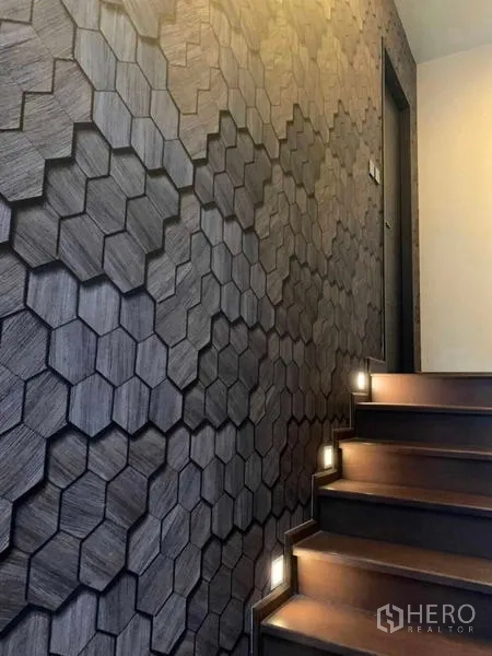 Condominium for rent or sale in Huai Khwang, Bangkok - Wooden staircase with step lighting and a dark hexagon textured feature wall.