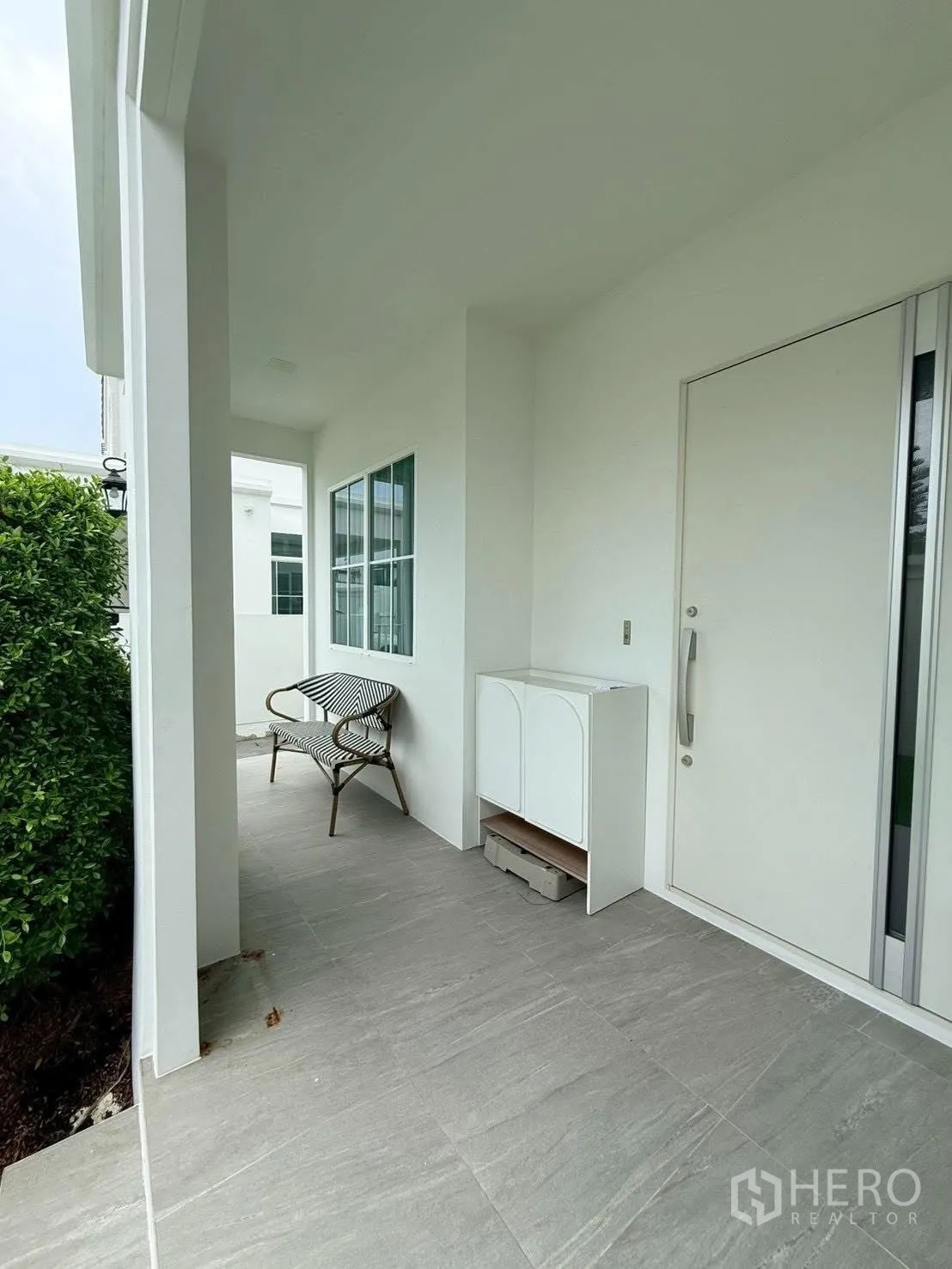 Detached House for rent in Bang Phli, Samut Prakan - Covered front porch with seating and a white entrance door.