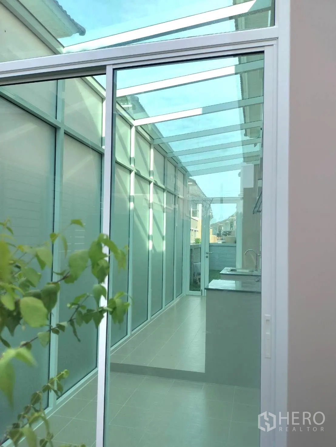 Detached House for rent in Lat Krabang, Bangkok - Enclosed glass-roofed corridor with sliding doors and a side counter.