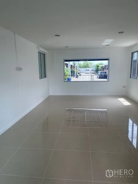 Townhouse for sale - Spacious front living room with large picture window and polished floor