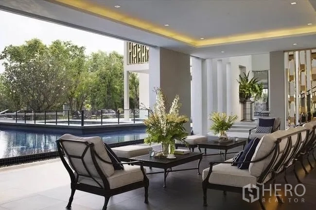 Detached House for sale in Prawet, Bangkok - Estate clubhouse lounge with seating overlooking the swimming pool.