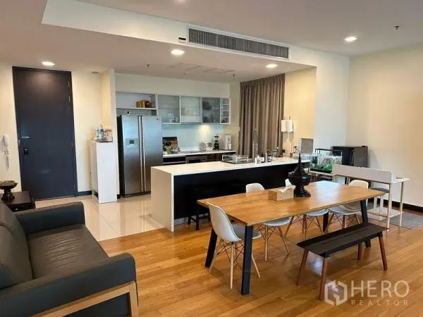 Condominium for rent in Yan Nawa, Bangkok - Open-plan living and dining area with island kitchen, wood floors, and stainless double-door fridge.